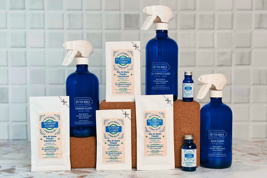 Refill sizes of spray cleaner powder concentrates in home-compostable pouches with reusable cobalt glass spray bottles